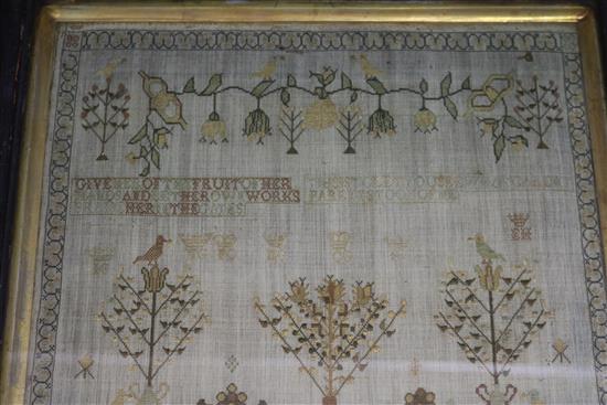 A George III needlework sampler, work with a country house, shrubs and birds, dated 1813